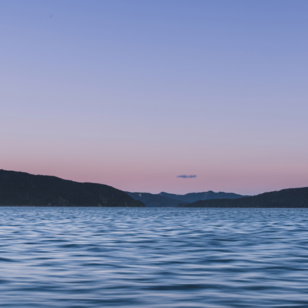 The Marlborough Sounds water, hills and full moon at sunset, Marlborough, New Zealand.