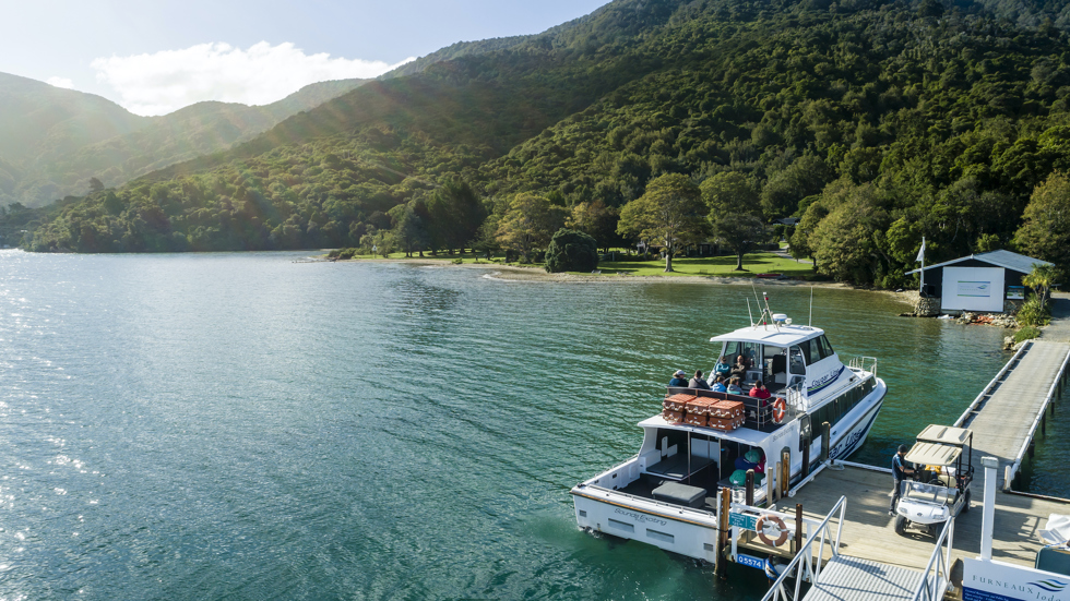 A Cougar Line boat tied up to the jetty at Furneaux Lodge in Endeavour Inlet, Marlborough Sounds, New Zealand.