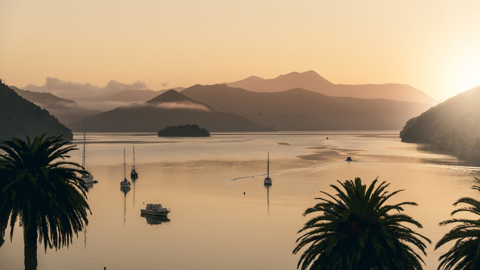 Orange sunrise over Picton Harbour and the Queen Charlotte Sound/Totaranui, at the top of New Zealand's South Island..