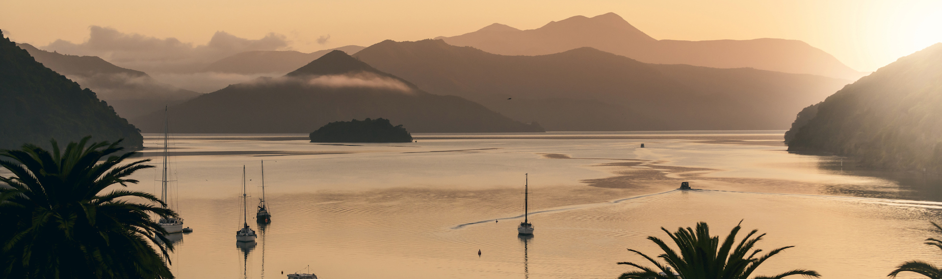 Orange sunrise over Picton Harbour and the Queen Charlotte Sound/Totaranui, at the top of New Zealand's South Island..