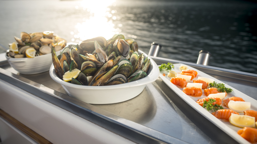 Cloudy Bay Clams, Greenshell mussels and Regal salmon are served at the source on a Seafood Odyssea cruise in New Zealand's spectacular Marlborough Sounds from Picton.