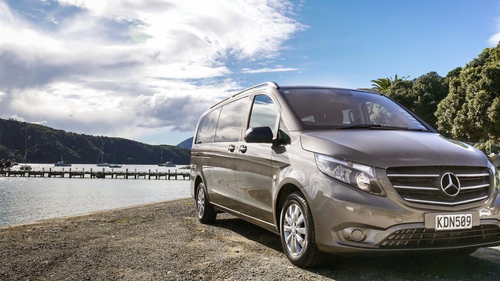 Van parked on waterfront at Picton awaiting pick up for a wine tour or transfer, in Marlborough at the top of New Zealand's South Island.